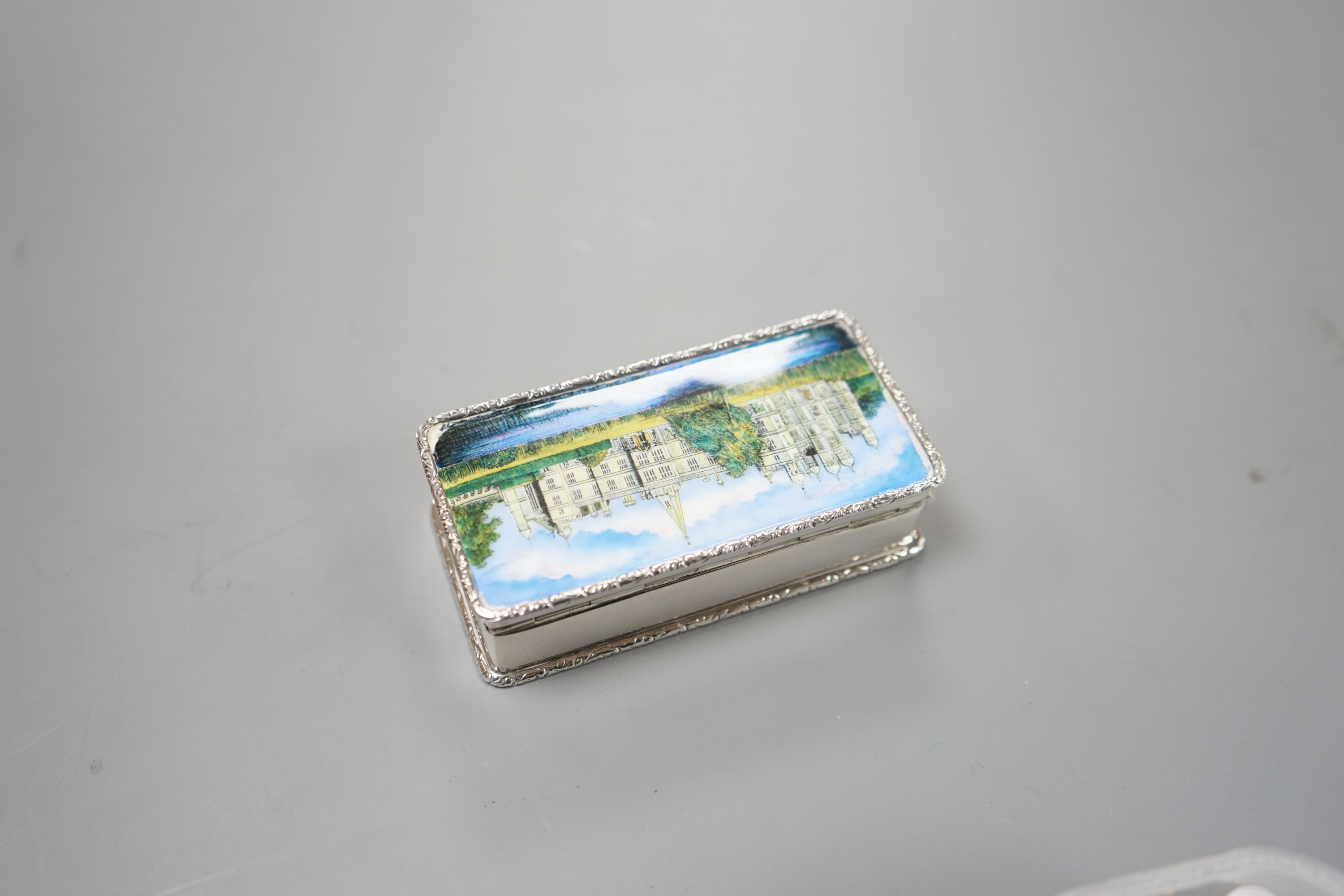 A modern Garrard & Co silver and enamel snuff box, decorated with manor house scene, Birmingham, 1986, 94mm, gross 147 grams.